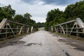 A stretch of the original route 66 wih an old steel bridge in the State of Missouri