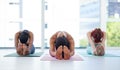 Stretch out and wake up your body. a group of sporty young women touching their toes while exercising in a yoga studio. Royalty Free Stock Photo