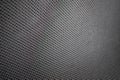 Stretched grey mesh textured polyester fabric.