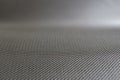 Stretched grey mesh textured polyester fabric.