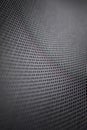 Stretched grey mesh textured polyester fabric.