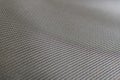 Stretched grey mesh polyester fabric.