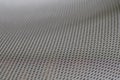 Stretched grey mesh textured polyester fabric.