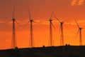 countryside with wind turbines and the setting sun