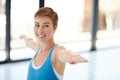 Stretched and unstressed. a young woman practising yoga at the gym.