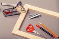 Stretcher for canvas, staple gun and other tools on a gray background Royalty Free Stock Photo