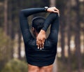 Stretching arms, fitness and back of woman in nature for exercise, training and sports in forest. Hiking, mountain and Royalty Free Stock Photo