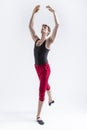 Stretching of Concentrated Contemporary Ballet Dancer Flexible Athletic Man Posing in Red Tights in Ballanced Dance Pose With