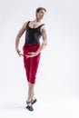 Stretching of Concentrated Contemporary Ballet Dancer Flexible Athletic Man Posing in Red Tights in Ballanced Dance Pose With