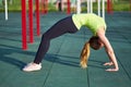 Stretching danser or gymnast woman training trains in workout sports ground. Doing exercise bridge