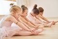 Stretching exercises. Little ballerinas preparing for performance Royalty Free Stock Photo