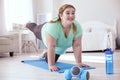 Plump young woman smiling during her workout session