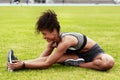 Stretching her limits. Full length shot of an attractive young female athlete warming up at the track. Royalty Free Stock Photo