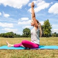Stretching and meditating outside, young woman exercising Royalty Free Stock Photo
