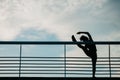 Stretching for muscles before marathon. Silhouette of african american girl, does exercises for legs Royalty Free Stock Photo