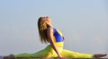 Stretching muscles. Woman practicing split. Flexible girl outdoor. Attractive woman practicing yoga. Splits exercise