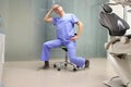 Stretching neck.Middle age dentist exercising,