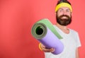 Stretching and pilates concept. Athlete sport coach. Man bearded athlete hold fitness mat red background. Athlete coach