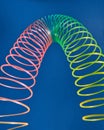 Stretching slinky toy in the shape of parabola. Royalty Free Stock Photo