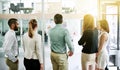 Stretching their business potential with a brainstorming session. Rearview shot of a team of colleagues having a Royalty Free Stock Photo