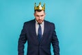 Strict bossy man in official style suit and golden crown, being on position of top manager or boss