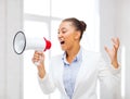 Strict businesswoman shouting in megaphone Royalty Free Stock Photo