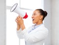 Strict businesswoman shouting in megaphone Royalty Free Stock Photo