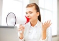Strict businesswoman shouting in megaphone Royalty Free Stock Photo