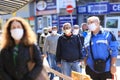 With strict control and disinfection people, wearing face masks for prevention of coronavirus COVID-19 disease, in a line for Royalty Free Stock Photo