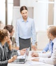 Strict female boss talking to business team