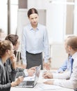 Strict female boss talking to business team