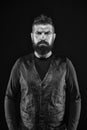 Strict mature face. Facial hair. Male face. Handsome face. Fashion model. Man with beard in black leather clothes. Man Royalty Free Stock Photo