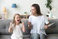 Strict mom scolding ill-behaved daughter screaming loud at home Royalty Free Stock Photo