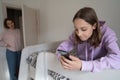 Strict mother lecturing teenage daughter for long smartphone use