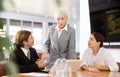 Strict senior female boss conducting work meeting with subordinates