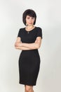 A strict serious woman black dress with slits at the waist