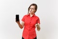 Strict severe serious teacher woman user in red shirt hold mobile smart phone with blank empty screen to copy space Royalty Free Stock Photo