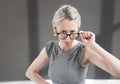 Strict teacher looking through glasses with serious expression Royalty Free Stock Photo