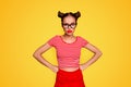 Strict teacher Portrait of grimacing offended young gorgeous woman model with with hands on waist and bun hairstyle Royalty Free Stock Photo