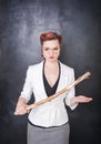 Strict teacher with wooden stick on blackboard background Royalty Free Stock Photo