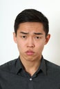 Strict young Asian man looking at camera Royalty Free Stock Photo
