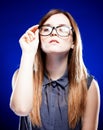 Strict young woman holding nerd glasses