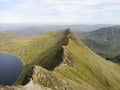 Striding Edge mountain peak near a lake with a blue sky in the background, Lake District, England Royalty Free Stock Photo