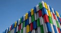 Colorful stacked containers forming a modern architectural structure against a clear blue sky Royalty Free Stock Photo