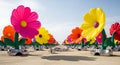 Giant vibrant inflatable flowers line a desert path Royalty Free Stock Photo