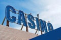 Striking blue Neon Casino sign, towering against a wispy sky