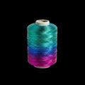 Vibrant Gradient Multicolored Thread Spool Isolated on Black Royalty Free Stock Photo