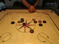 Striking the coins by striker on carrom board