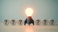 Bright idea concept featuring rocket and lightbulb rising above question marks Royalty Free Stock Photo