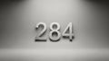 Metallic Silver 3D Number 284 on Grey Background Royalty Free Stock Photo